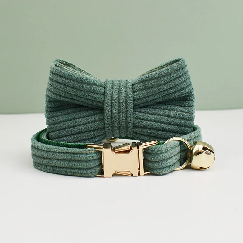 Green dog leash with a gold clasp and bell on a light background