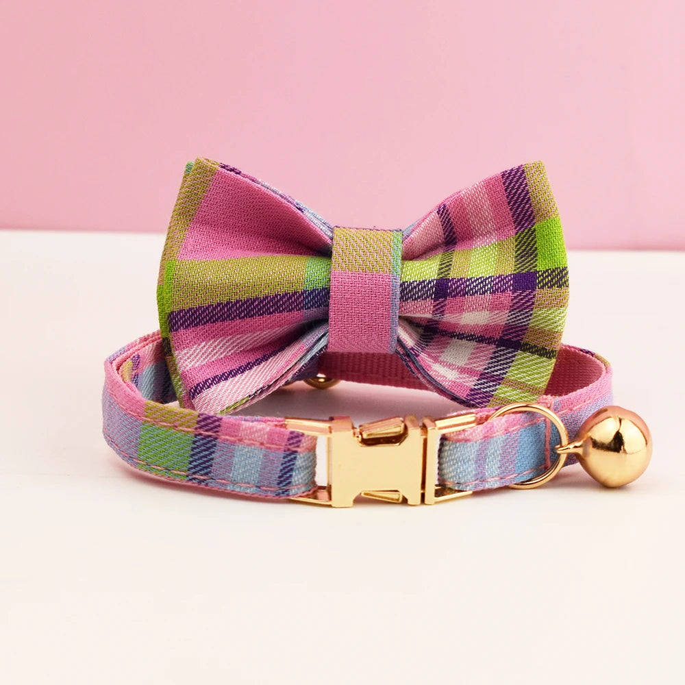 Plaid dog collar with a bow tie and gold clasp on a pink background