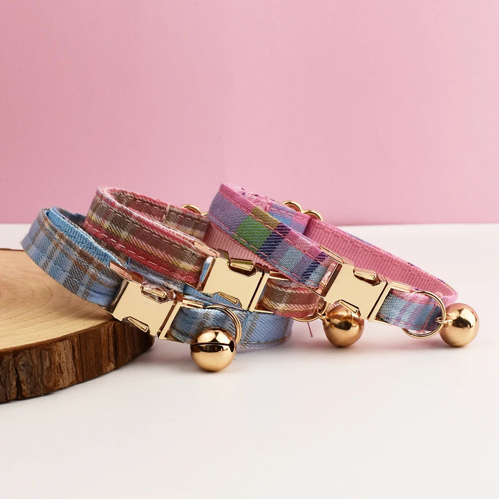 Multicolored dog collar with gold hardware on a pink background
